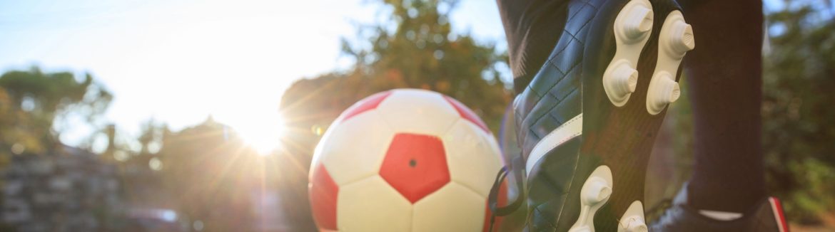 Woman and a soccer ball on the grass